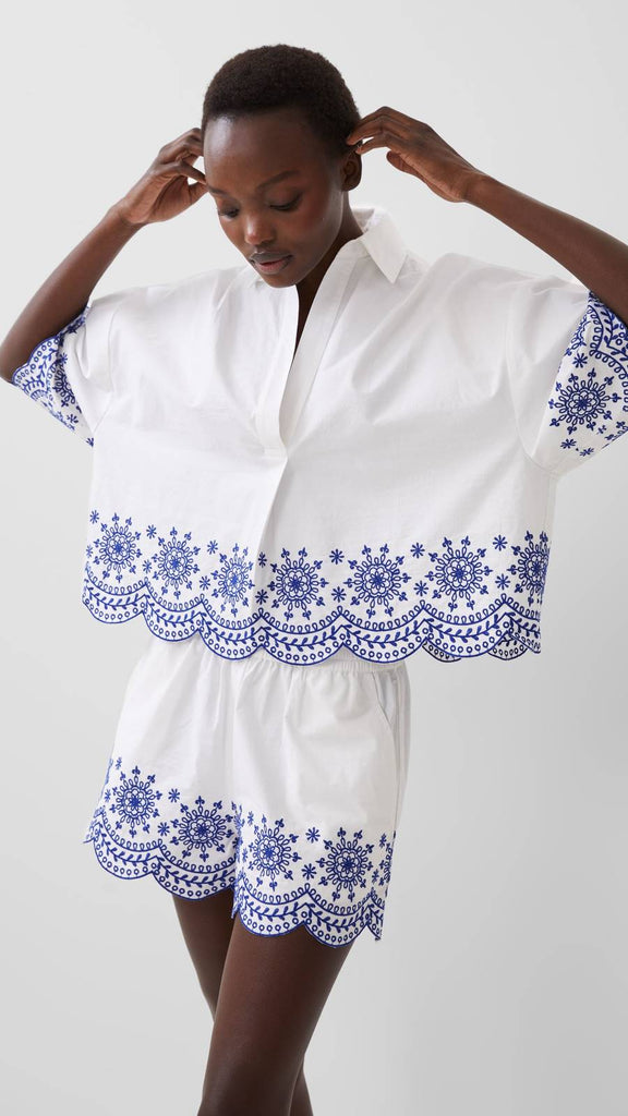 white and blue embroidered top