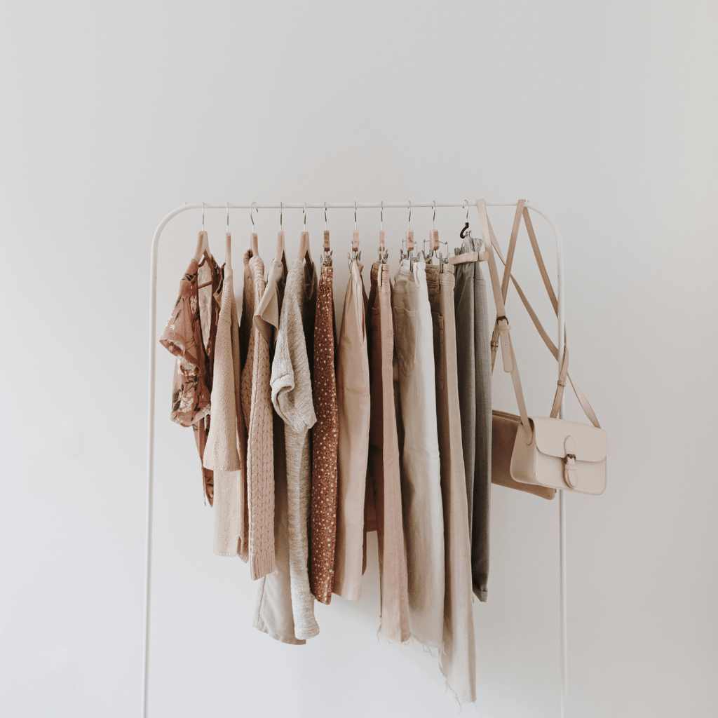 rack with neutral clothing and bags